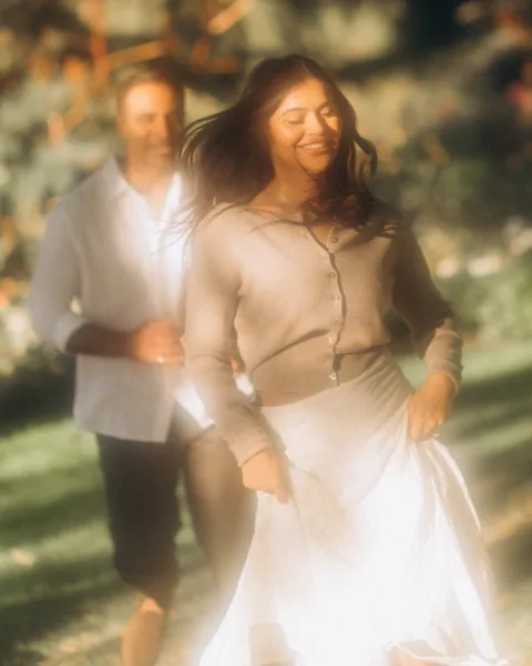Sumera and Ammar walking in a garden